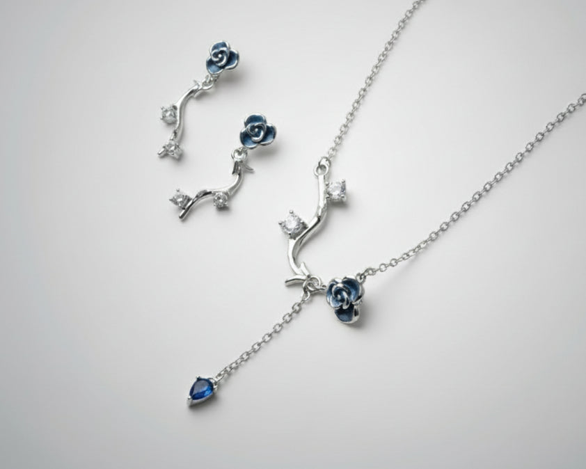 Silver jewelry set with floral design on a white background by silverlab
