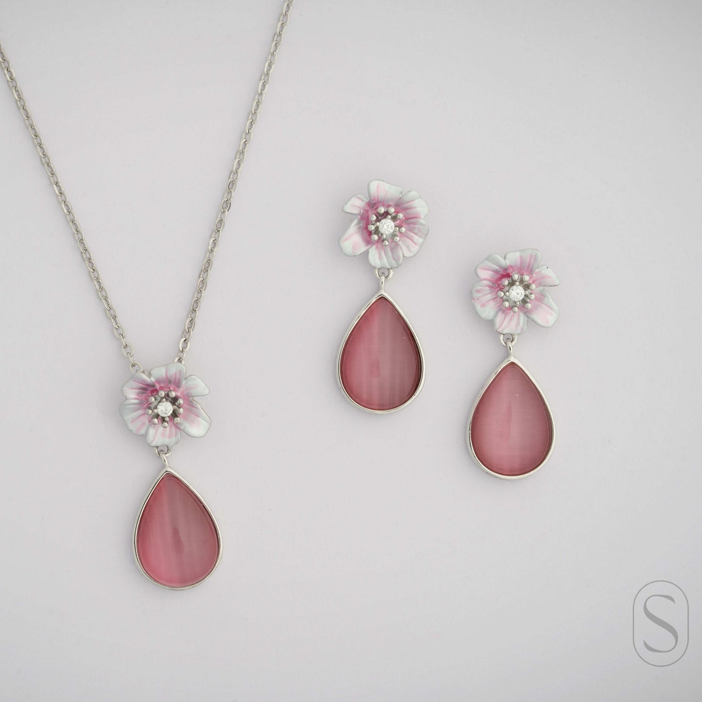 Pink teardrop necklace and earrings on a light gray background by silverlab