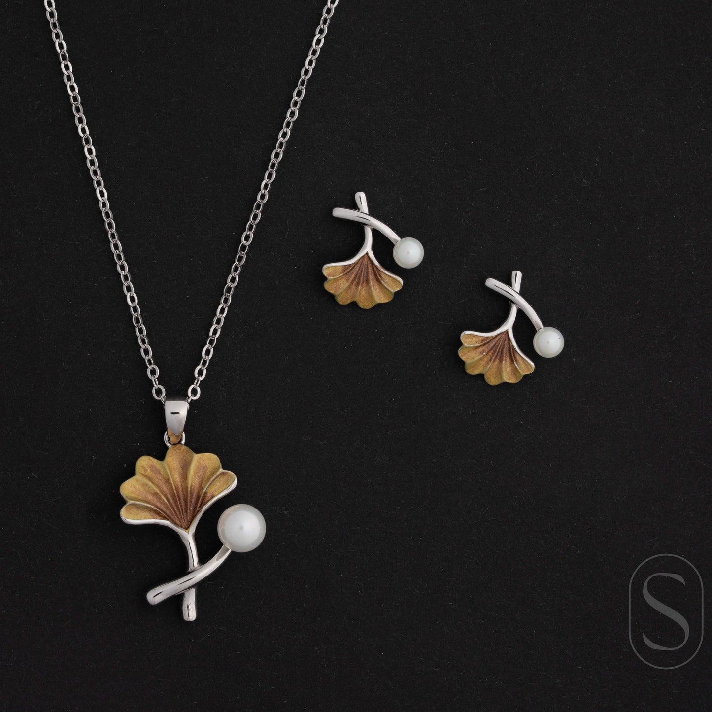 Jewelry set with pendant and earrings on a black background by Silverlab