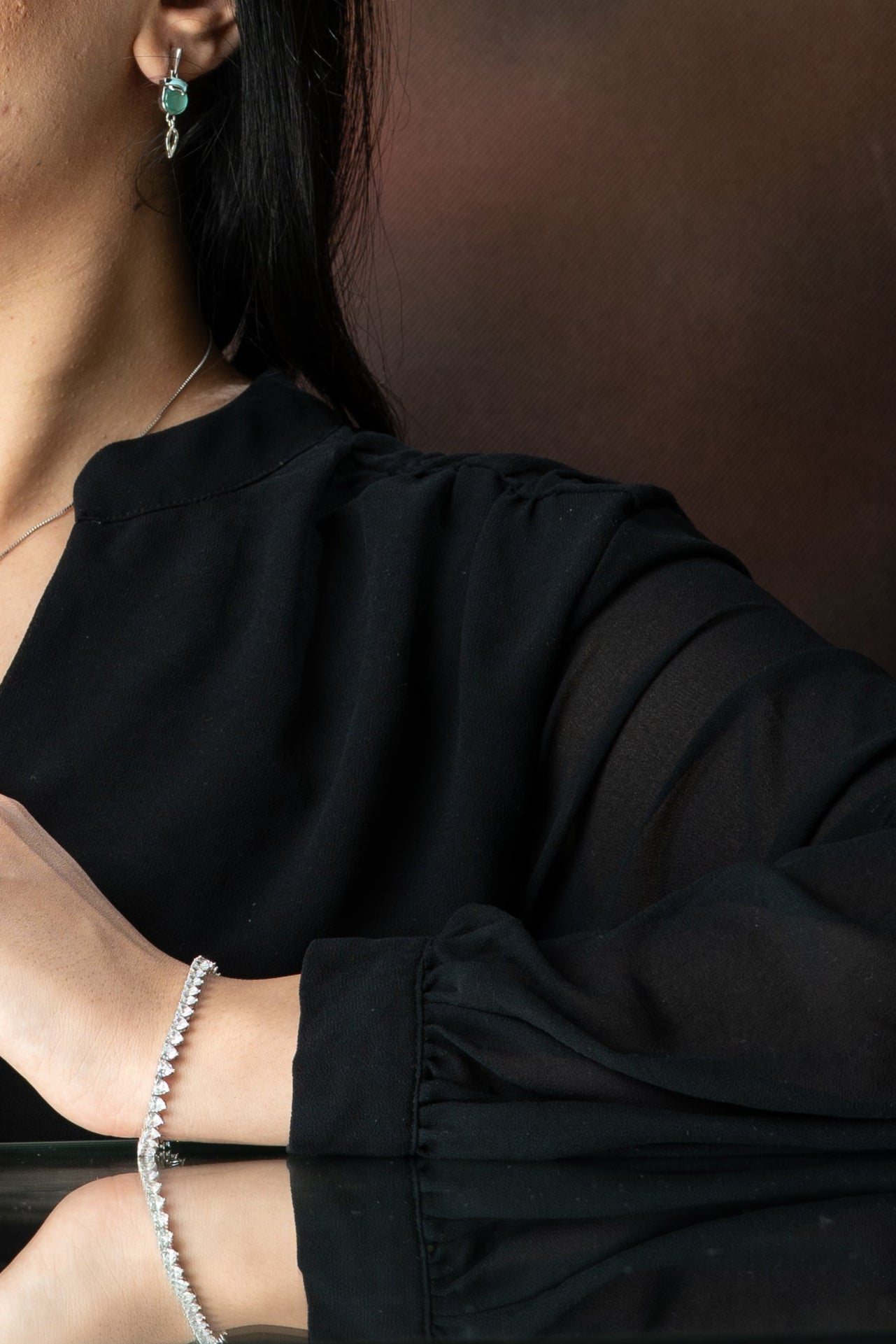 Person wearing a black shirt with a blurred background